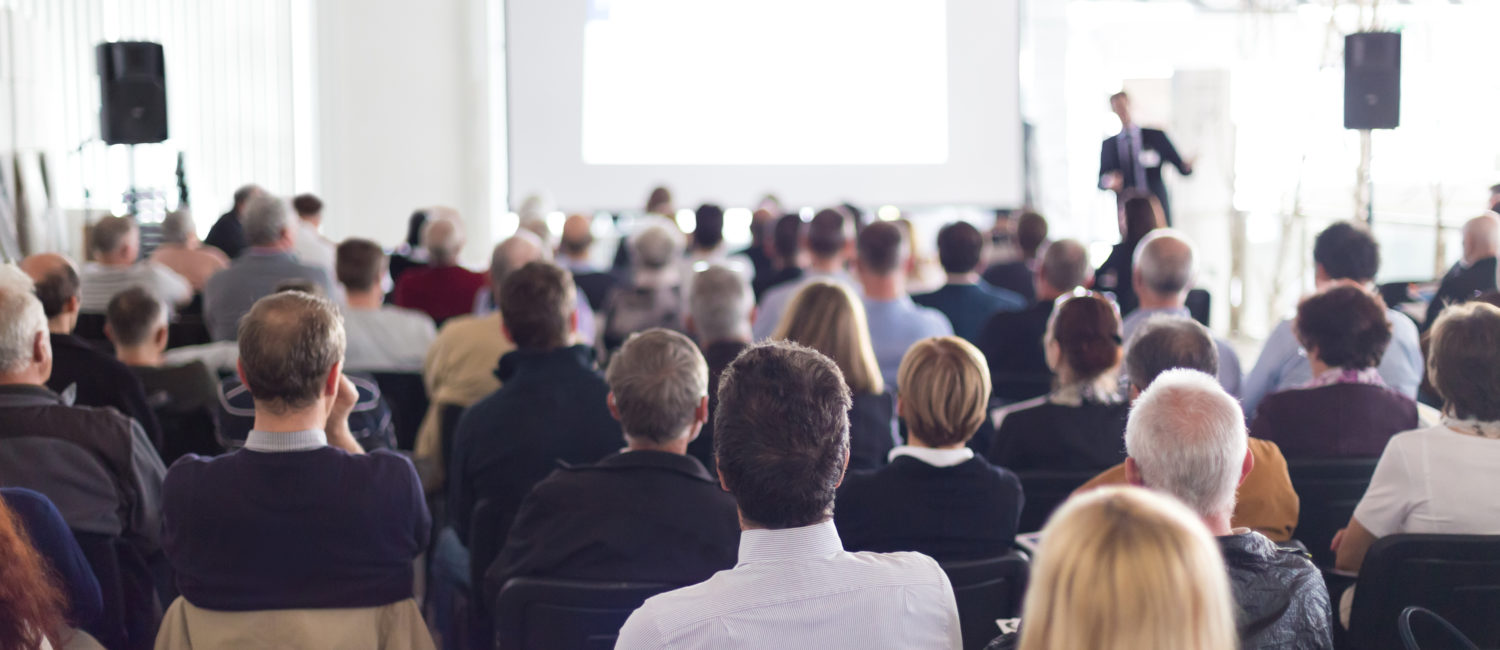 an instructor teaching a class or presenting at a conference