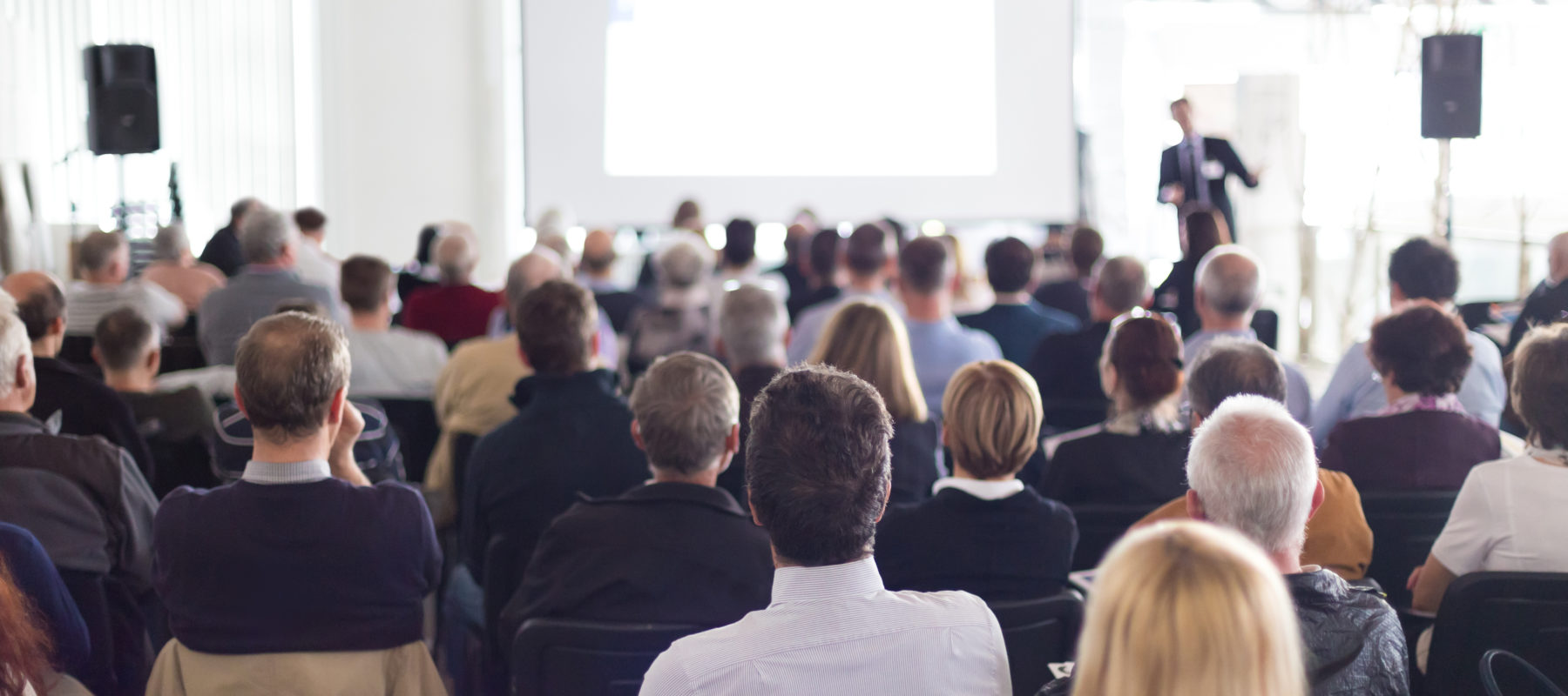 an instructor teaching a class or presenting at a conference